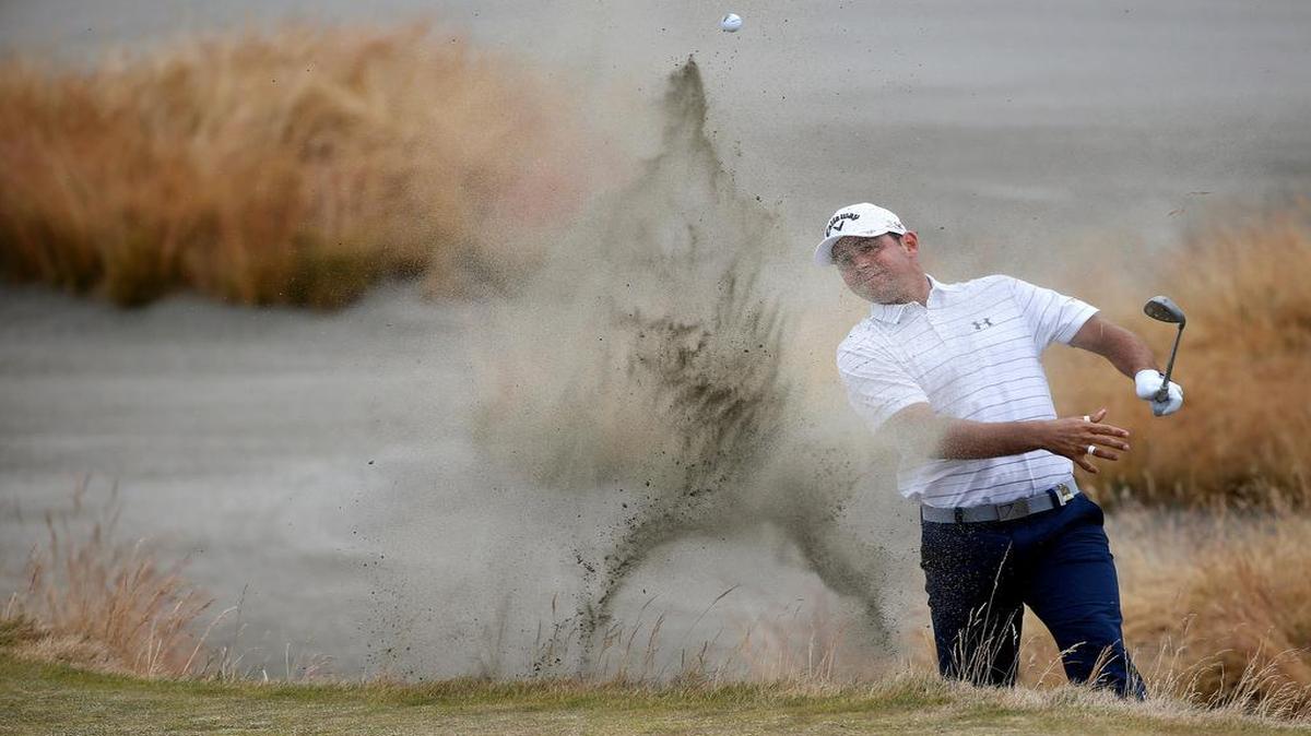 
Gary Woodland hits out of a bunker on the 15th hole during the first round of the U.S. Open at Chambers Bay on Thursday in University Place, Wash. 
