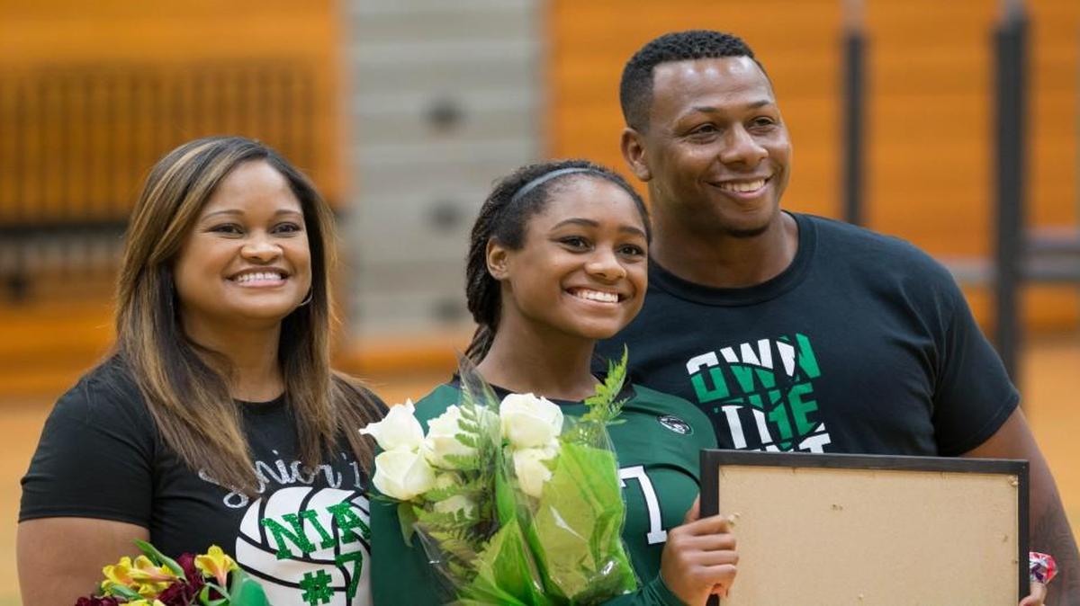 Nia Bishop and her mother, Mari Lou Mewborn, and father, Michael Bishop, are recognized on Derby’s senior night.
