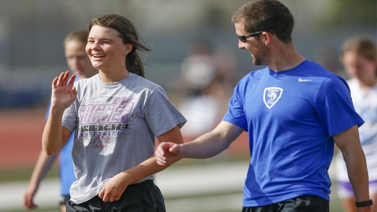 Kapaun senior Ashley Shepard jokes around with coach Anthony Cantele.