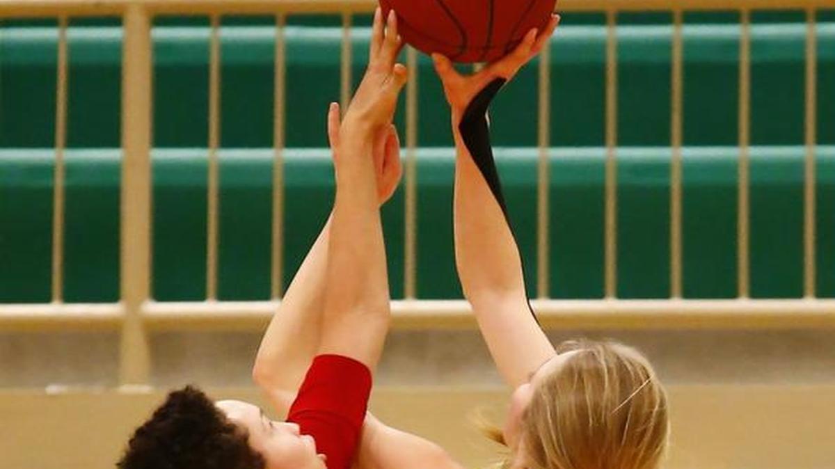 South's Kyla Callins, left, gets her hand on a shot by Carroll's Ashton McCorry in the first quarter Friday.