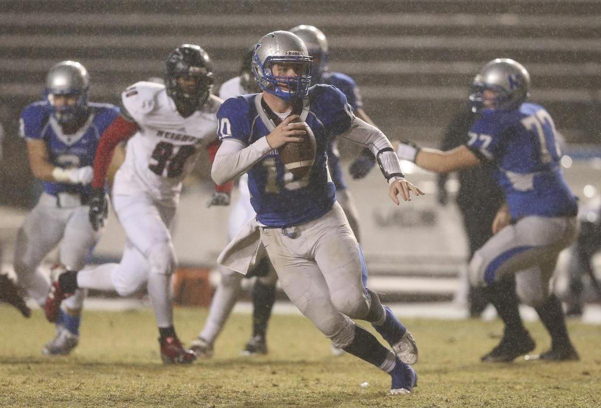 Kapaun quarterback Brock Monty scrambles during the second quarter against Heights on Friday night at Cessna Stadium.