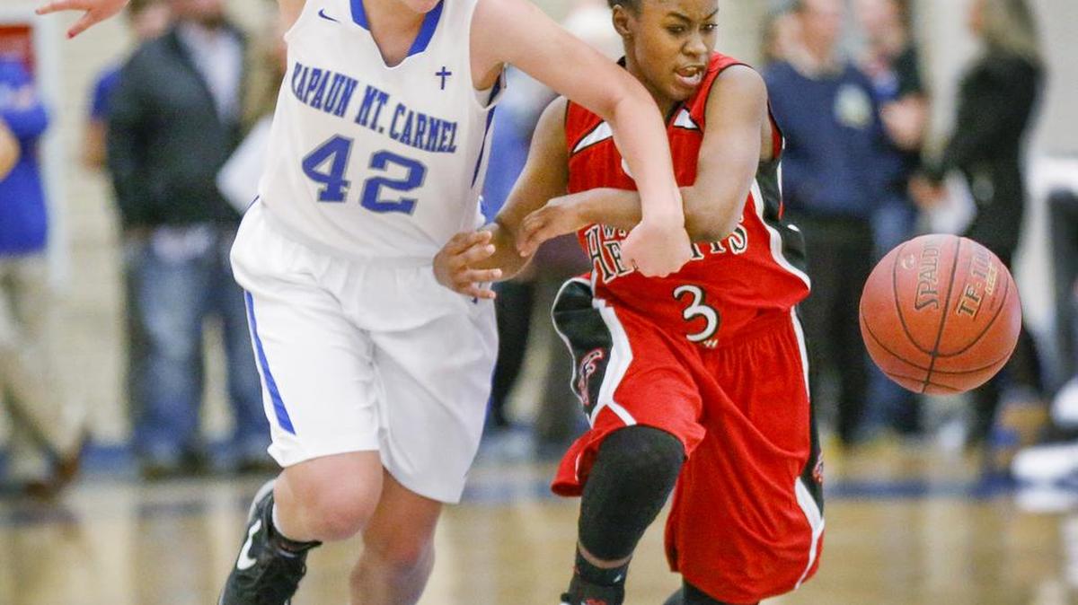 Heights' Dymond McElrath (3) steals the ball from Kapaun's Anna Roulston in the third quarter at Kapaun Mt. Carmel High Friday night. (Dec. 4, 2015)