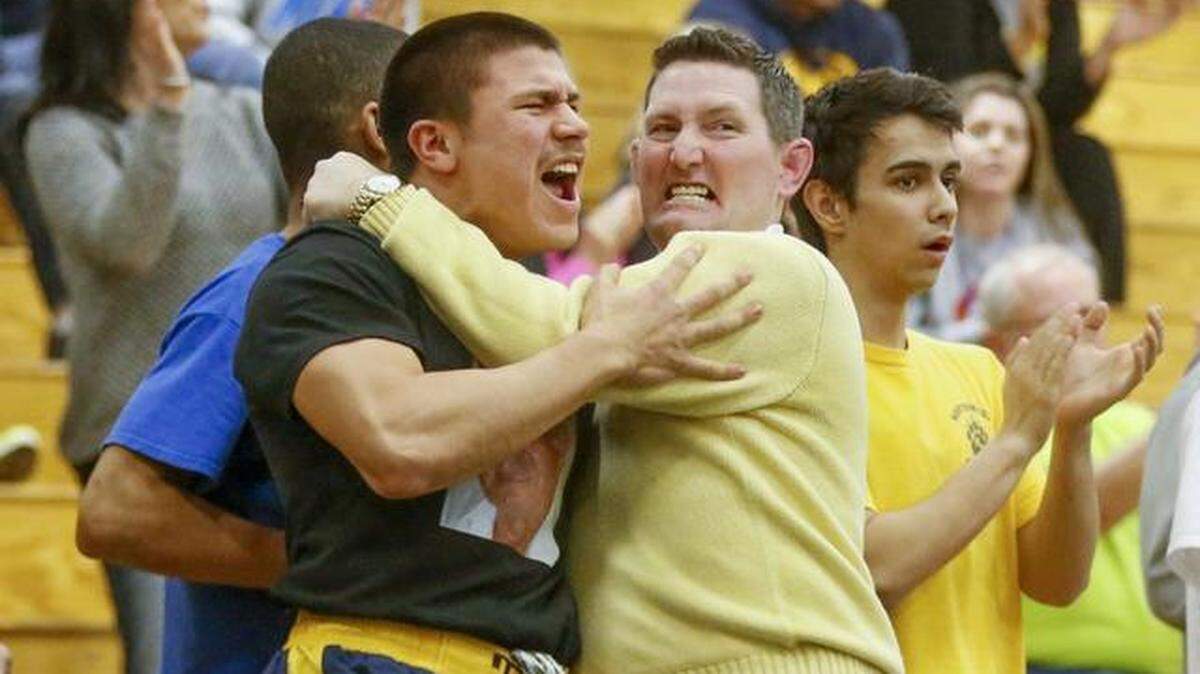 Northwest wrestling coach Eric Prichard hugs Saul Ortiz at the state meet. In a news release, Northwest announced Prichard died on Tuesday.