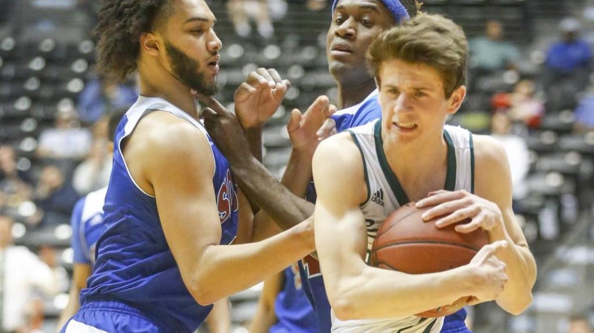 South's Malcolm Tate, left, fouls Lawrence-Free State's Garrett Luinstra, right, as he gets to a loose ball with seconds to play in their 6A quarterfinal game at the state championships at Koch Arena in Wichita, Ks. Wednesday. South lost 48-42.