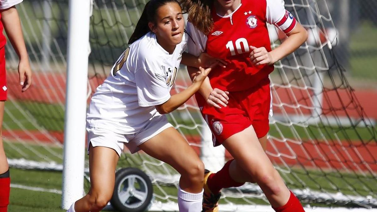 Maize South's Natalie Amaya, left, tries to control the ball as Miege's Megan Homoly defends near the Stags' goal in the first half Friday.