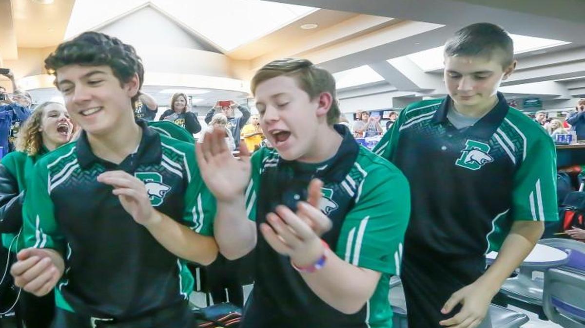Derby's Matthew Hedden, second from right, celebrates with Michael Klein, center, Garrett Bolden, right, and coach Alie Ijams, left, after their regional win last week.