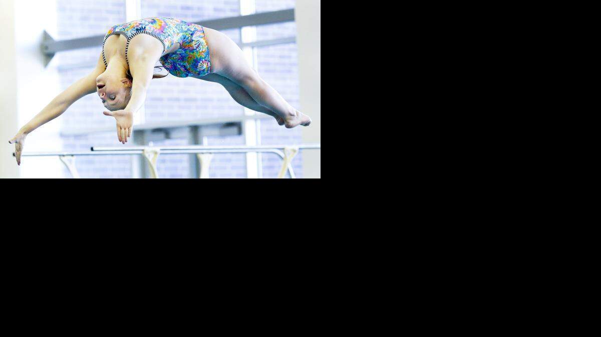 
Southeast diver Christine Maynard practices her dives during a workout at Northeast Magnet. She is deaf and uses a interpreter to help her communicate.
