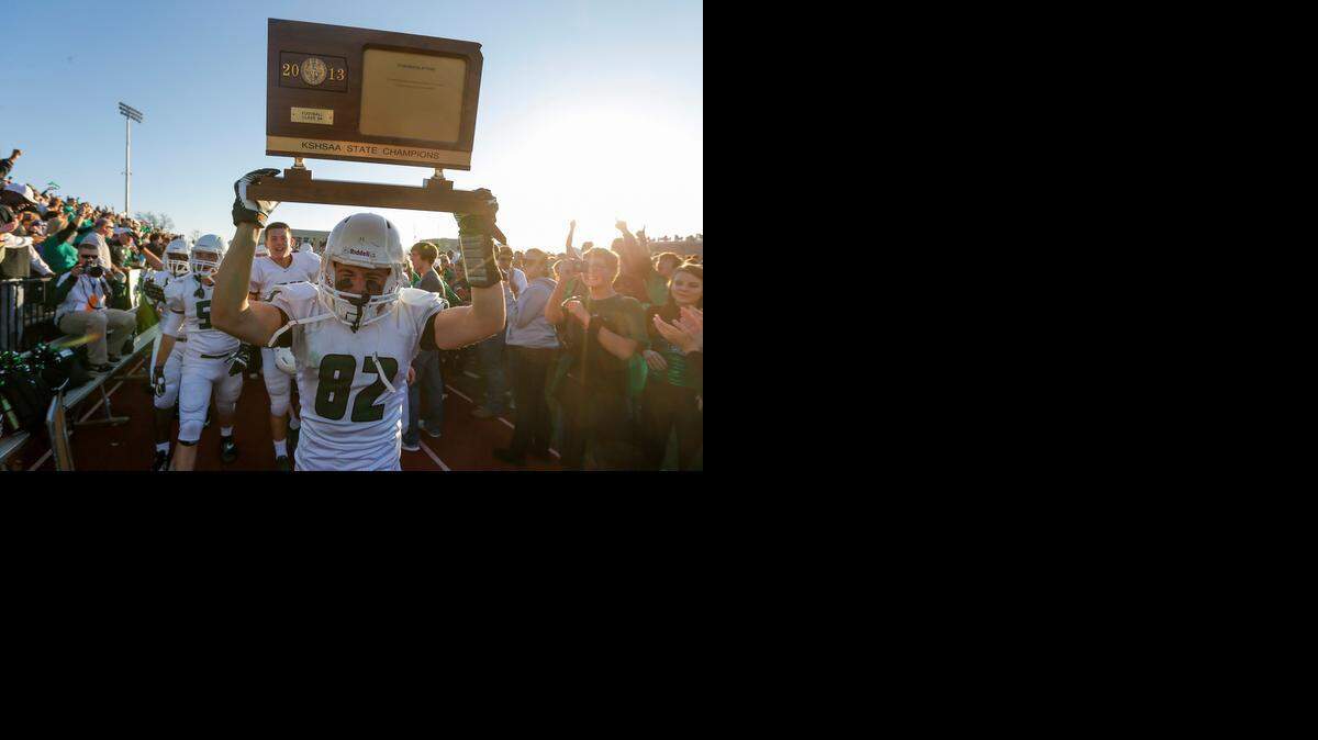
Derby's Luke Palmer parades around the 6A state championship trophy in 2013. Champions in six classes will be crowned Saturday.
