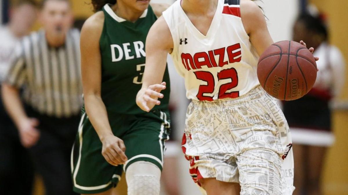 Maize's Taylor Holmes (22) brings the ball up court against Derby's Aliyah Myers in the second quarter.