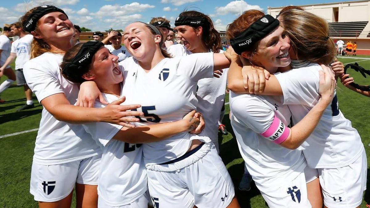 St. Thomas Aquinas players celebrate after winning the Class 5A soccer championship last season. A Wichita-area club coach wants his players to commit to training even during their high school season, which would make them ineligible for their high school teams.