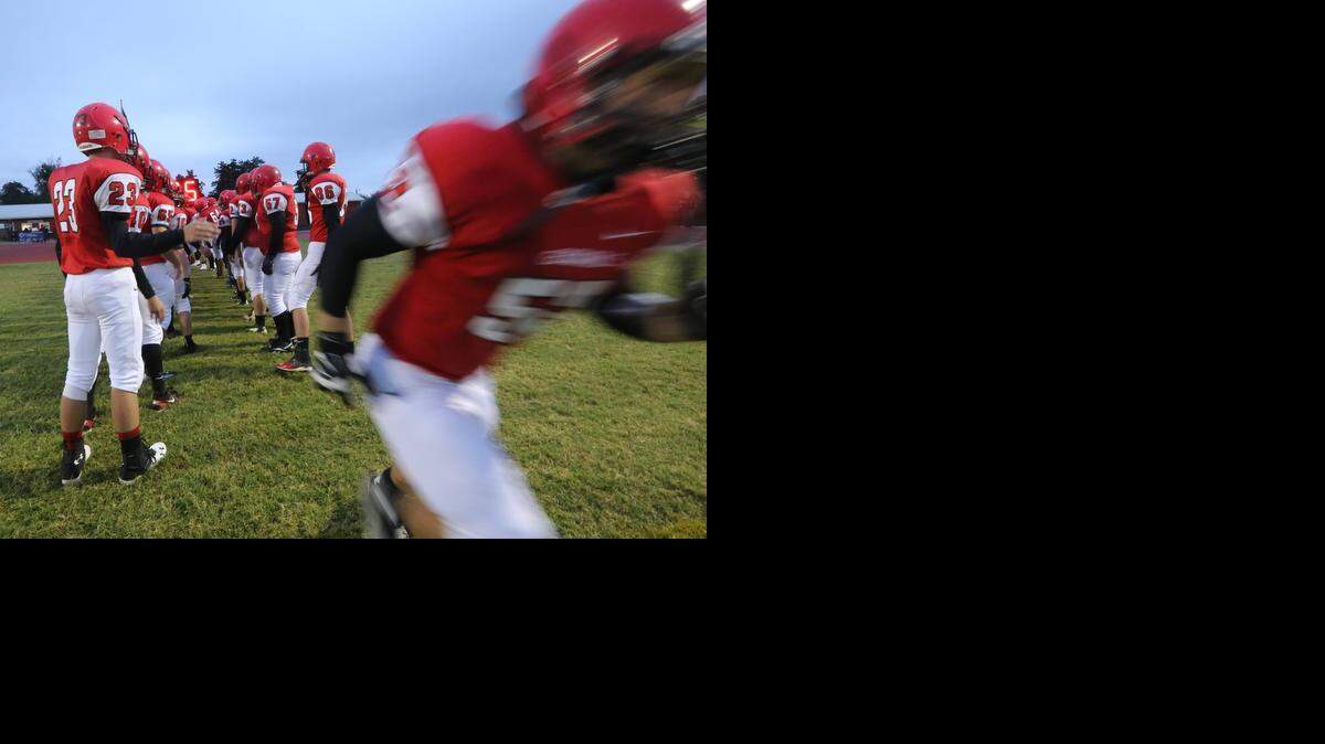 Conway Springs players take the field Friday night in Conway Springs, where they took on undefeated Trinity.