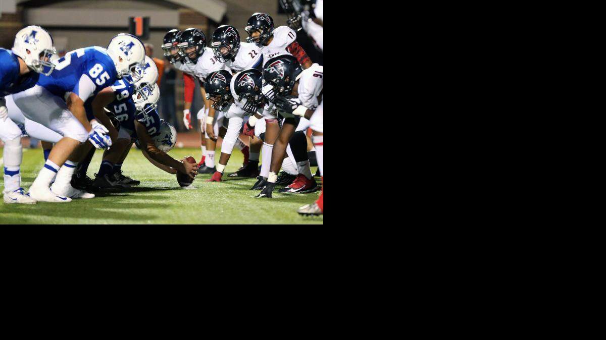 The Heights High defense stacks the line to stop the Andover High offensive running attack during the second quarter of Friday night's game at Andover District Stadium.
