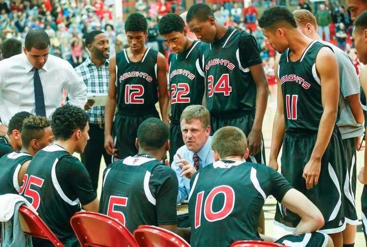 Heights boys basketball coach Joe Auer speaks with his team during a timeout in a 2015 game.