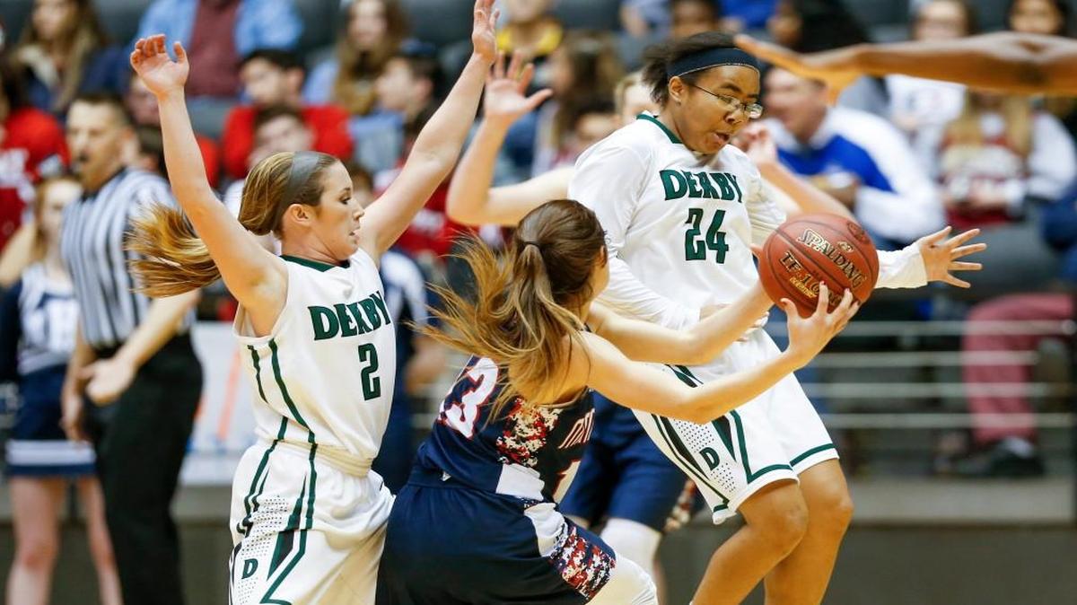 Derby's Madi Young, left, and Tore Alford, right, pressure Manhattan's Haleigh Harper into a turnover in the fourth quarter. Manhattan held off Derby’s comeback 44-42 in the Class 6A girls final.
