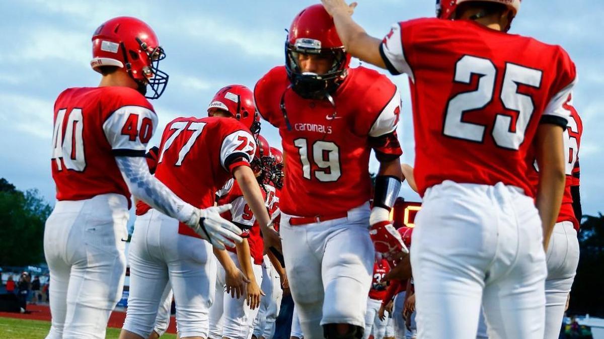 Conway Springs' Josh Dugan, middle, runs through a corridor of his teammates prior to playing Garden Plain.