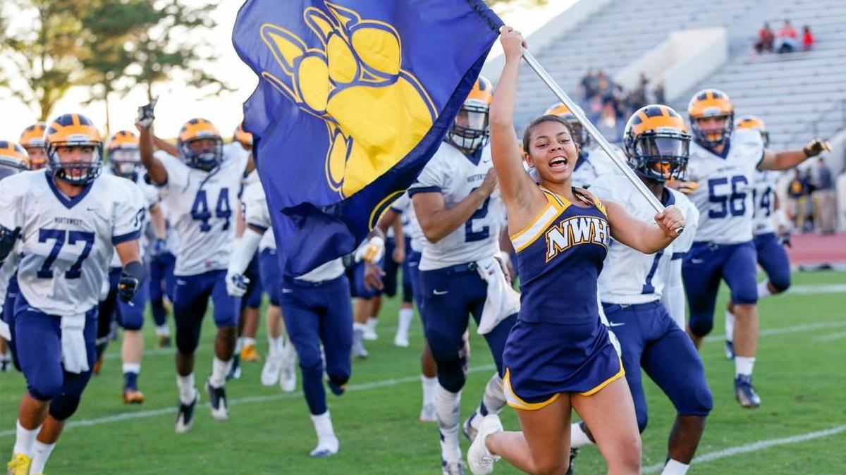 
The Northwest Grizzlies take the field before their game with Kapaun at Cessna Stadium on Friday. 

