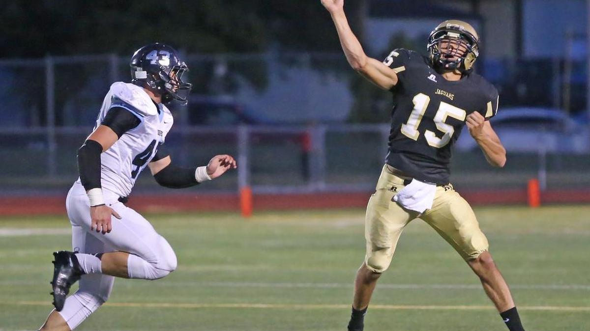 
Andover Central’s Petyon Huslig (15) throws across his body on a pass attempt against Eisenhower on Friday at Andover District Stadium.
