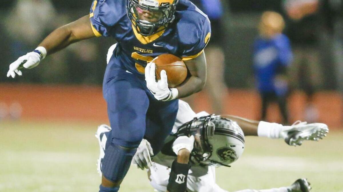 Northwest 's Jahlyl Rounds runs for yardage against Garden City's Patrick Clifford in the second quarter at Northwest High Friday.