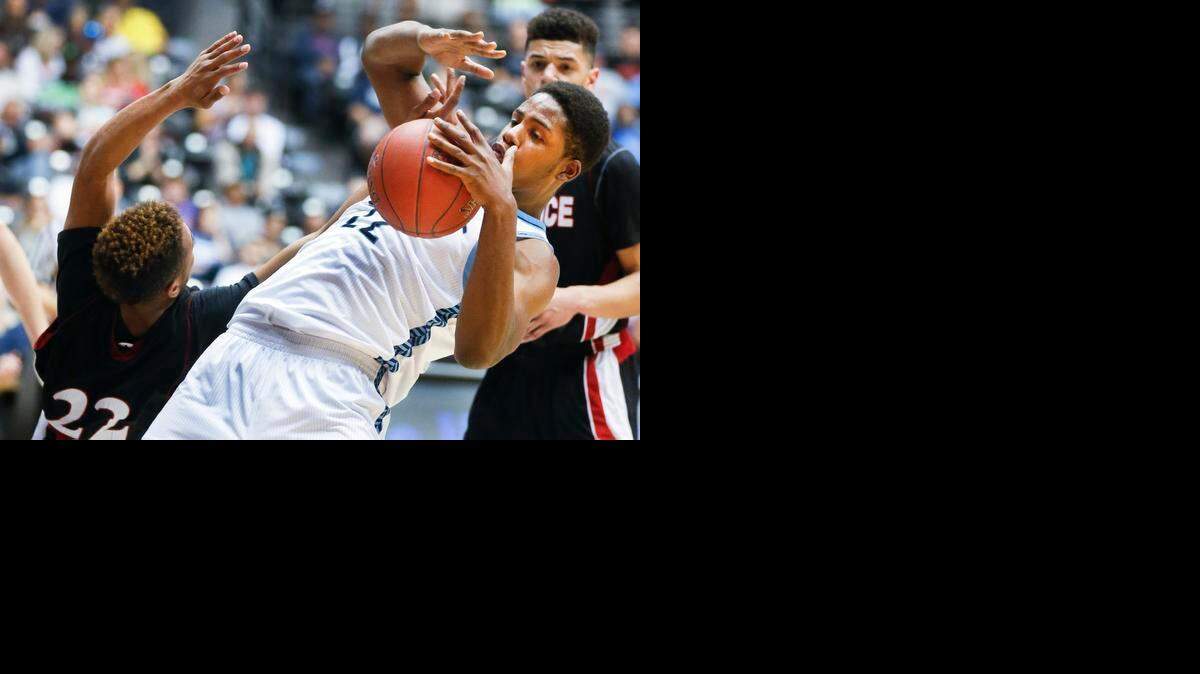 
East's Xavier Kelly fights for a rebound with Lawrence's John Barbee in the third quarter at the 6A State Championship game at Koch Arena Saturday. East beat Lawrence 58-43 to take the title. (March 14, 2015) 
