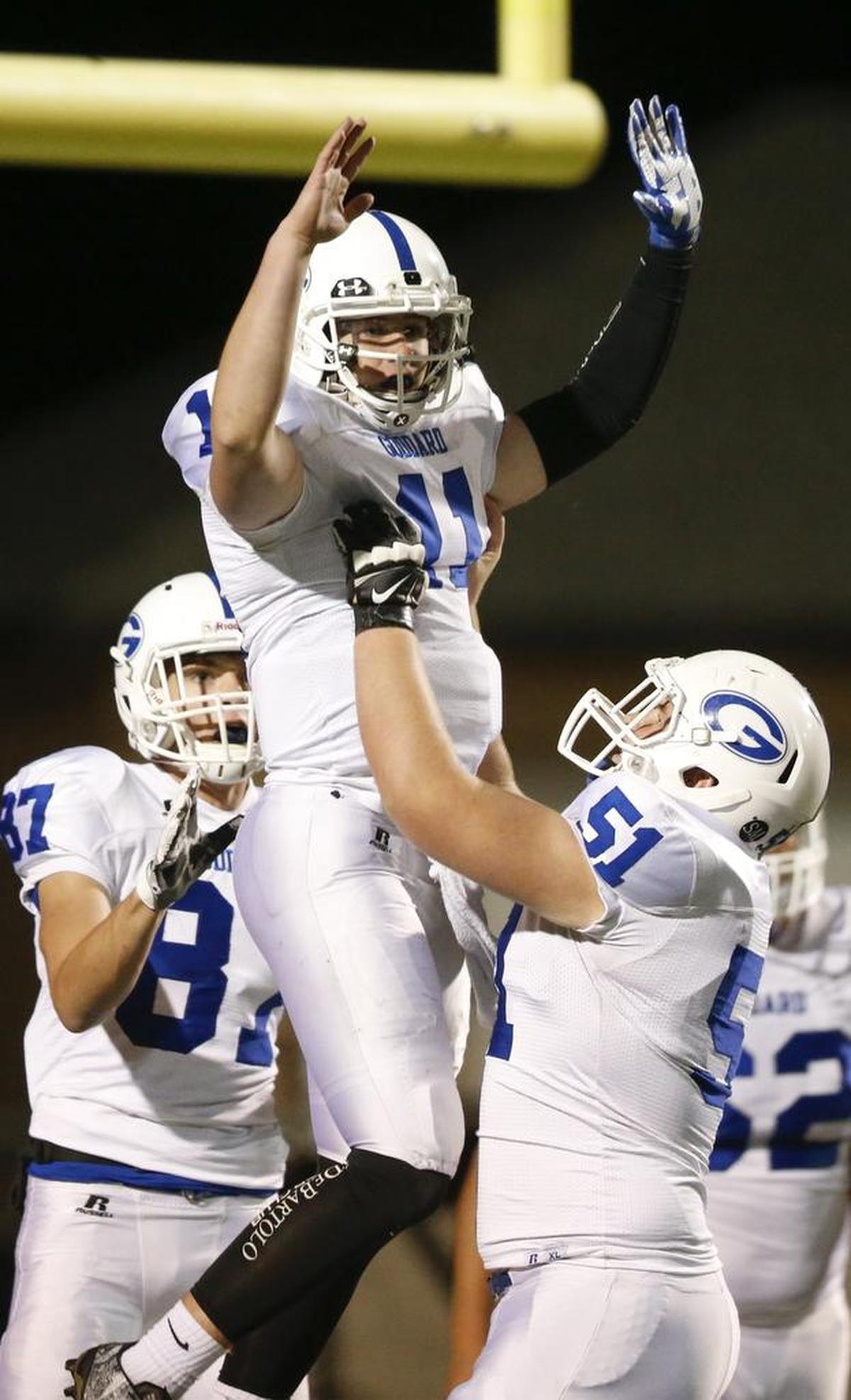 Goddard QB Blake Sullivan (11) celebrates with teammate A.J. Vang after scoring against Heights in the first quarter during their 5A quarterfinal playoff game at Heights Friday. (Nov. 11, 2016)