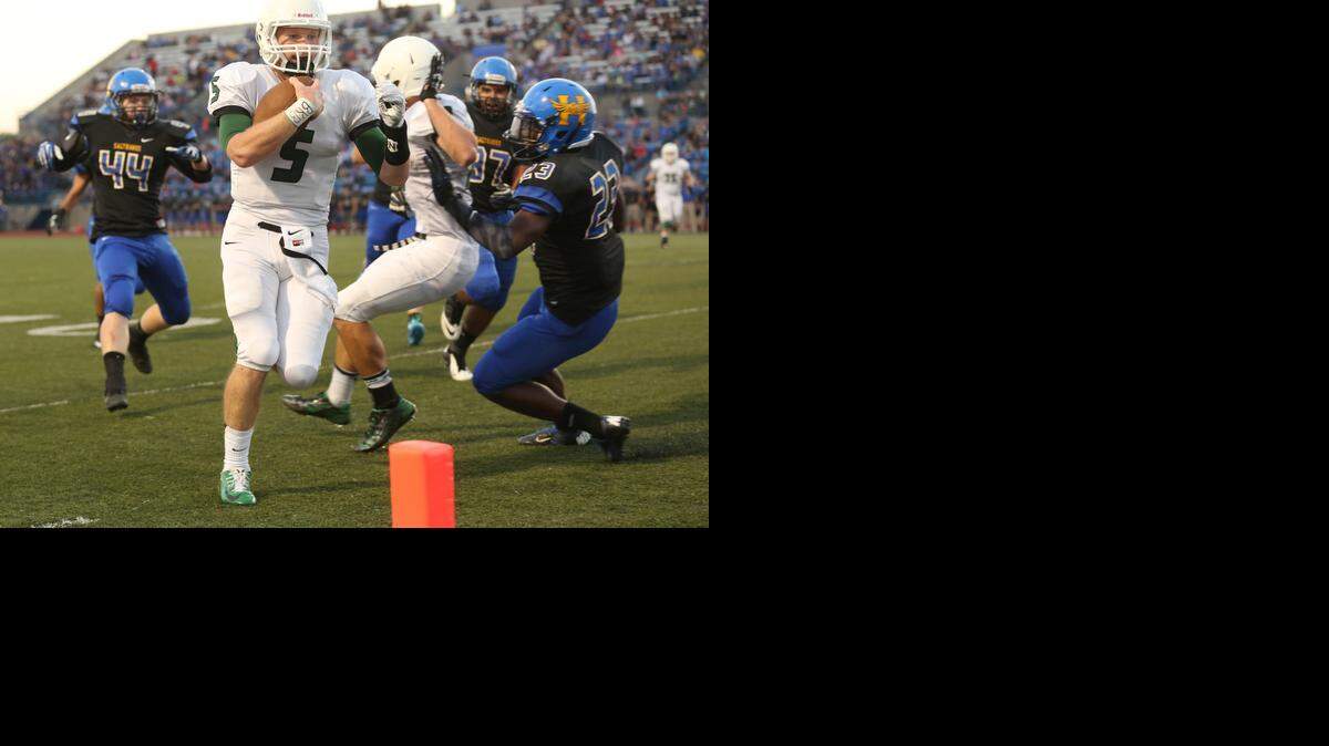 
Derby quarterback Brandon Curtis runs past Hutchinson's Braden Archer (44) and Luther Tolbert (32) for a touchdown in the first quarter Friday.
