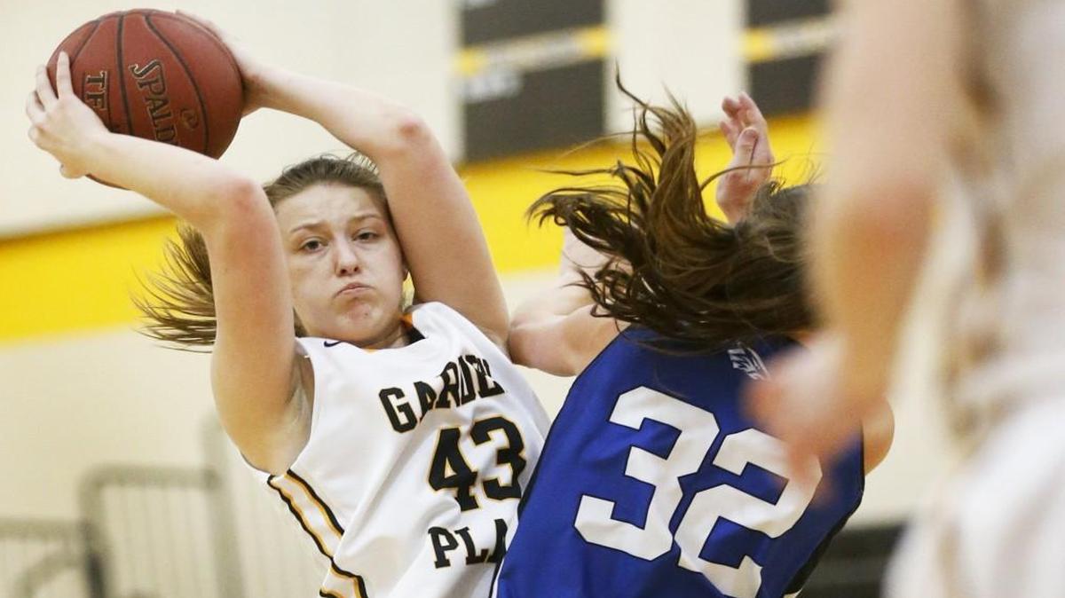 Garden Plain's Taylor Joplin (43) dishes the ball off after penetrating the lane against Independent in the first quarter of their 50-36 win Tuesday in Garden Plain.