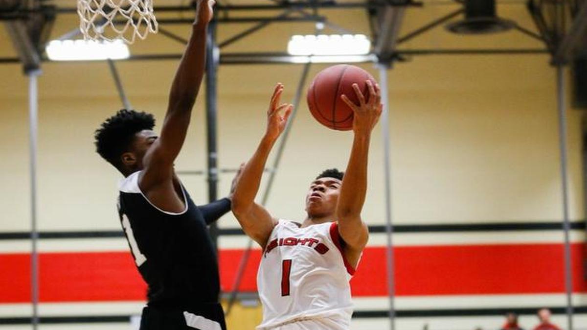 Heights’ Tyrell Andrews (1) attempts a layup against Southeast’s Israel Barnes in the first quarter Friday.