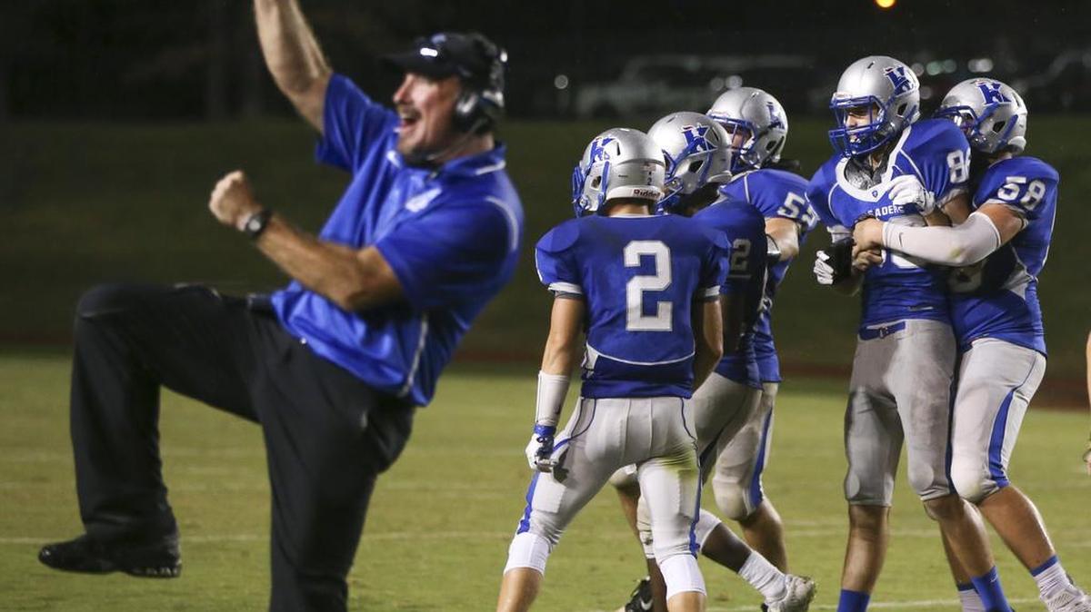 Kapaun coach Dan Adelhardt, left, celebrates after Kapaun kicker Preston Williams hit a 47-yard field goal in the fourth quarter of Friday’s game against West at Cessna Stadium.