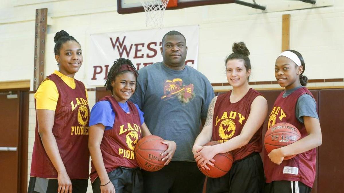West girls coach Brian Johnson, center, with his star players Destiny Pittman, Dymond McElrath, Mia Hays and Brianna Johnson. The program has taken off under Johnson in his first year.
