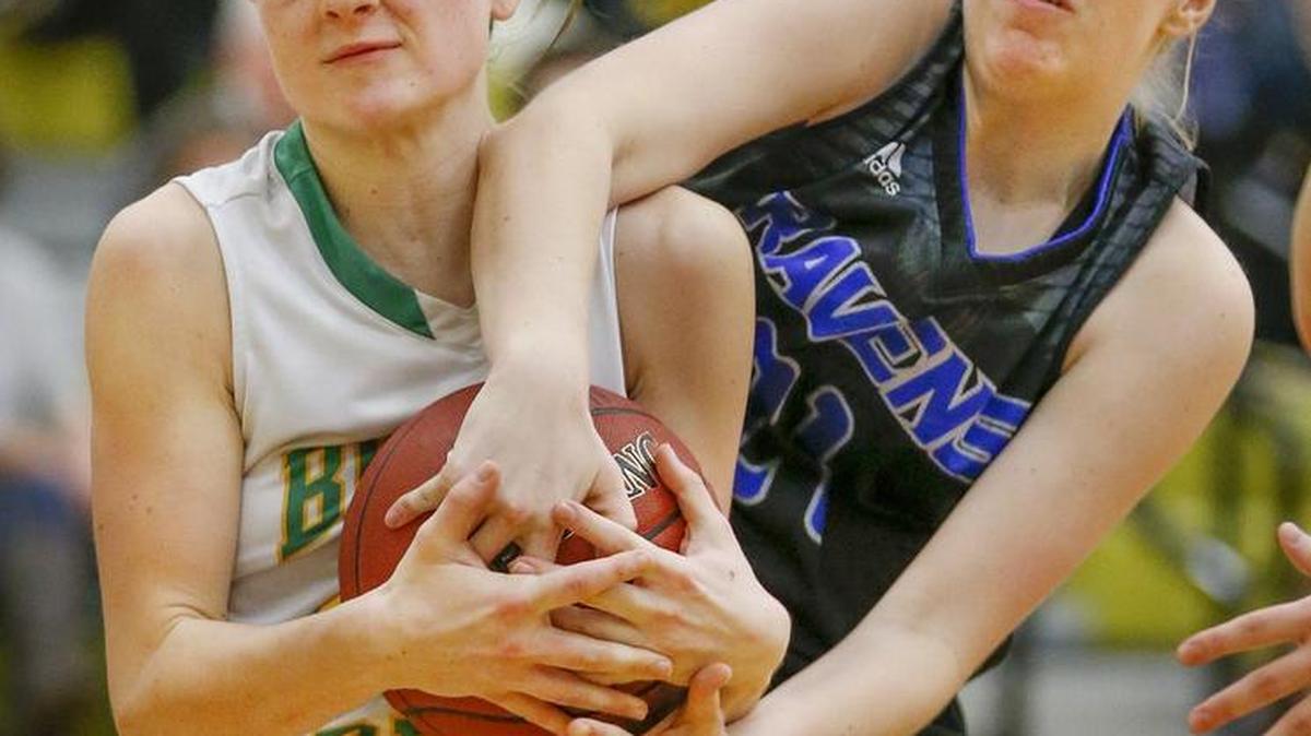Bishop Carroll’s Brynn Maul, left, and Olathe Northwest’s Kaylie Kappelmann fight for a rebound in the fourth quarter at the Newton Invitational Tournament on Thursday.