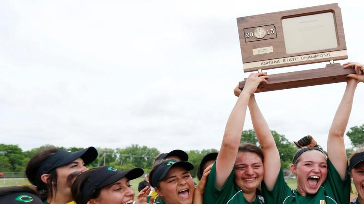 Carroll’s Brittany Finney (7), Meghan Gutierrez (1) and Leslie Hoffman (2) hoist the Class 5A championship trophy last May.