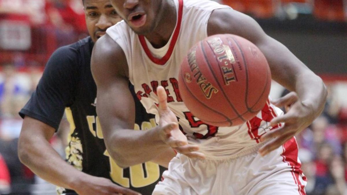McPherson's Spenser Wine (35) struggles to maintain control of the ball against Andover Central’s Darraja Parnell.