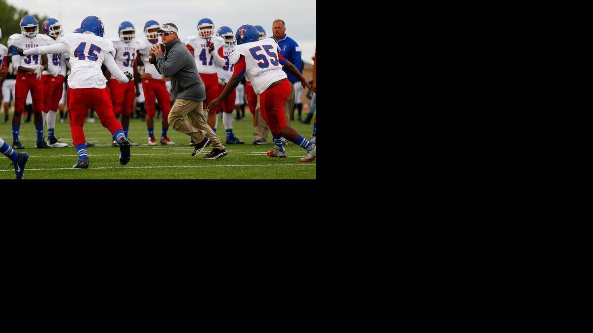 
South coach Bob Ray takes his players through some drills prior to their game against Heights on Sept. 12.
