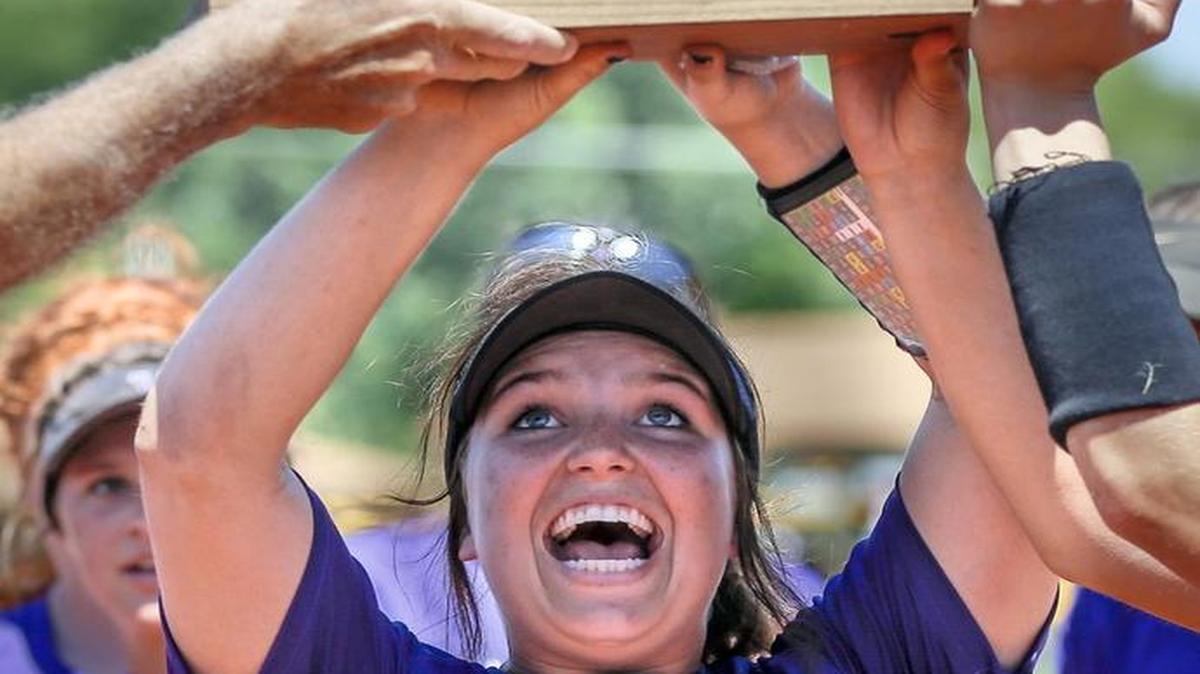 Valley Center's Wylie Glover holds the third-place trophy after defeating Mill Valley 10-2 in the Class 5A softball tournament Friday at Two Rivers Youth Complex.