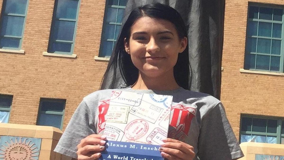 North senior Alexus Inscho holds a copy of her book, “A World Traveler’s Guide to Dermatology.”