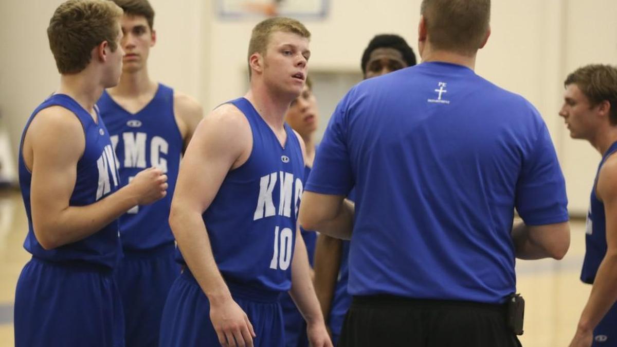 Kapaun basketball player Brock Monty listens to Coach John Cherne during practice.