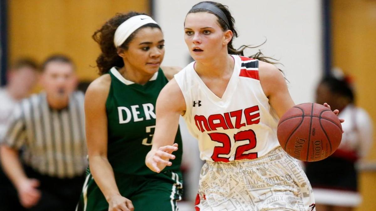 Maize's Taylor Holmes (22) brings the ball up court against Derby's Aliyah Myers.