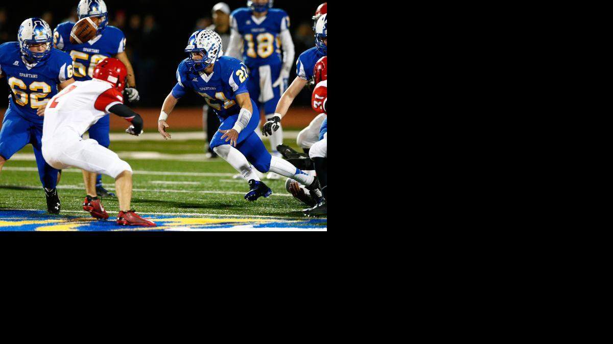 
Collegiate's Levi Aldag, right, fumbles the ball in the first quarter of the 3A playoffs against Conway Springs on Tuesday night.
