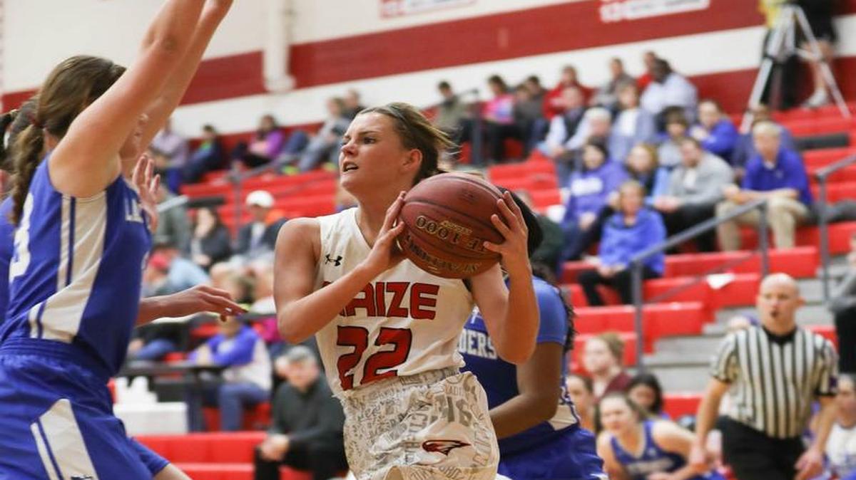 Maize’s Taylor Holmes drives into the paint against Kapaun Mount Carmel’s Megan Michaelis on Friday at Maize.
