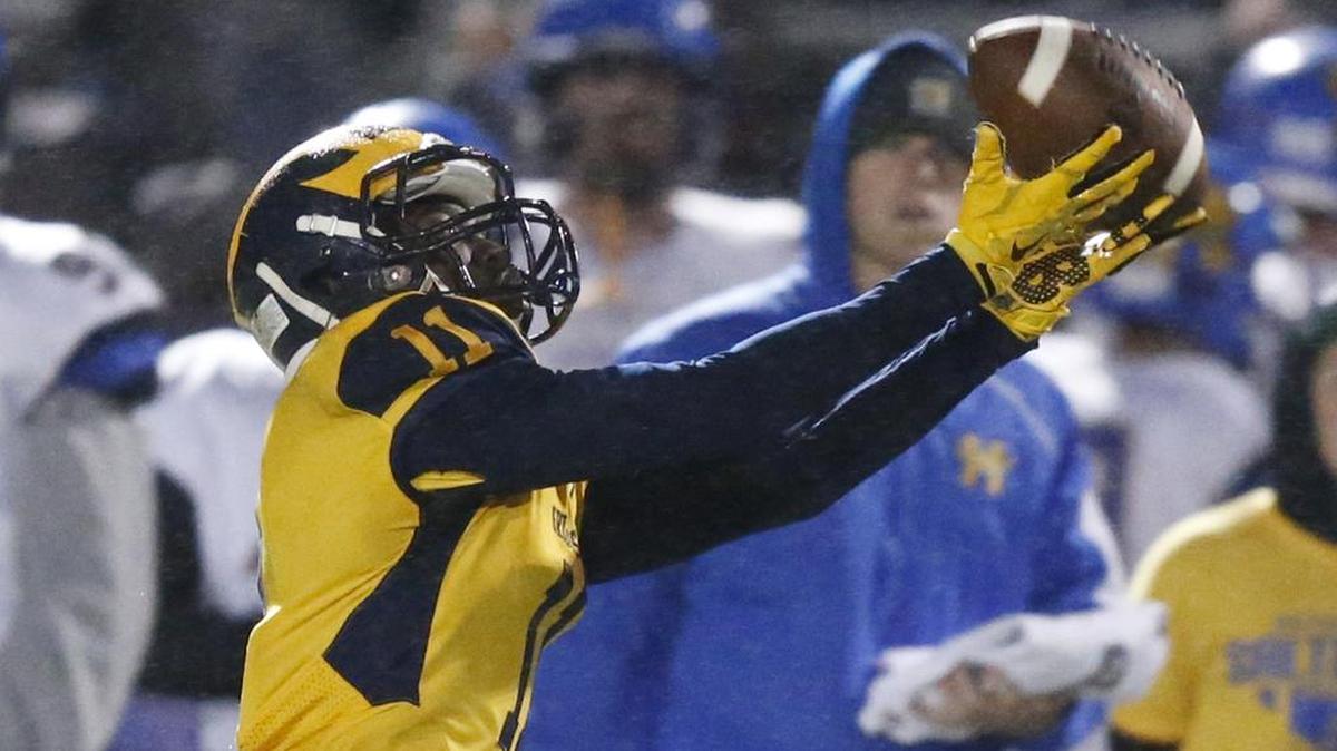 Northwest’s Martese Mullins catches a long pass from quarterback Kevin Folsom for a touchdown Friday night against Hutchinson.