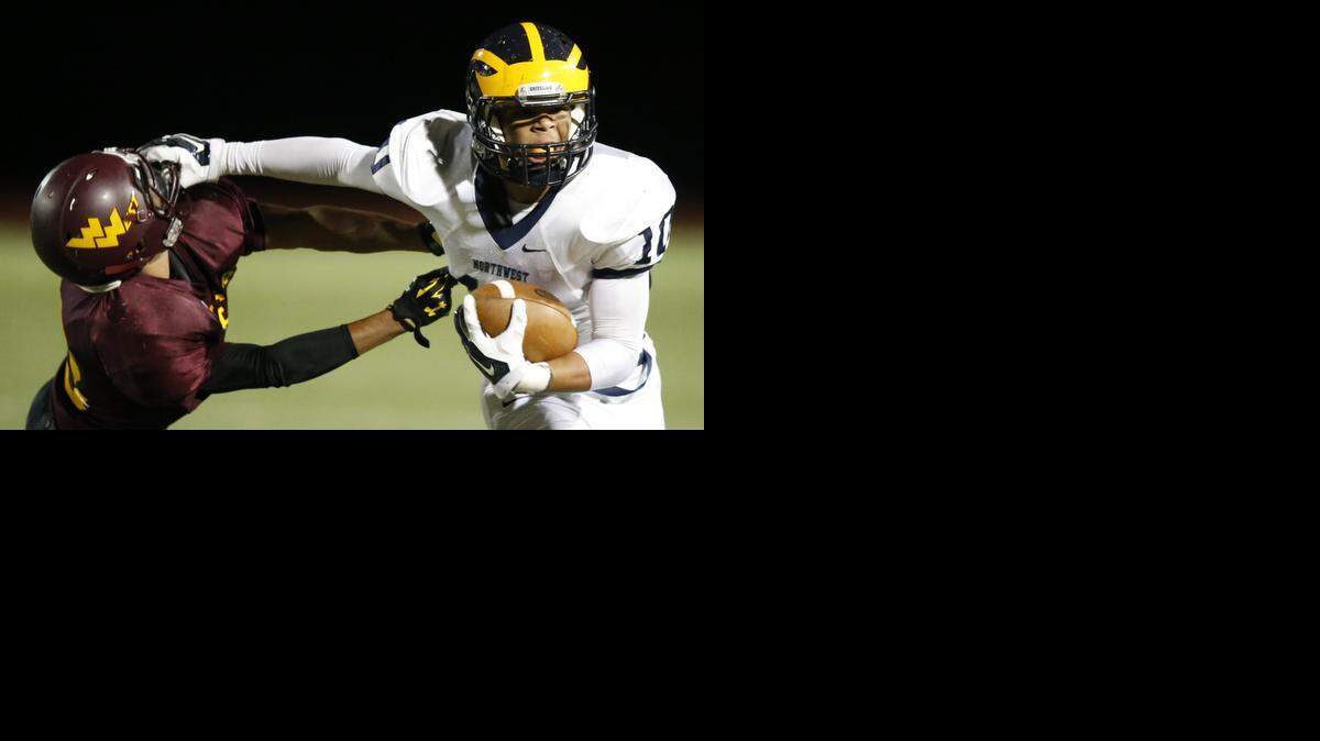 
Norhtwest's Alex Bott, right, stiff-arms West defender Terrell Rodriguez after catching a pass from Northwest's Kevin Folsom on Friday night.
