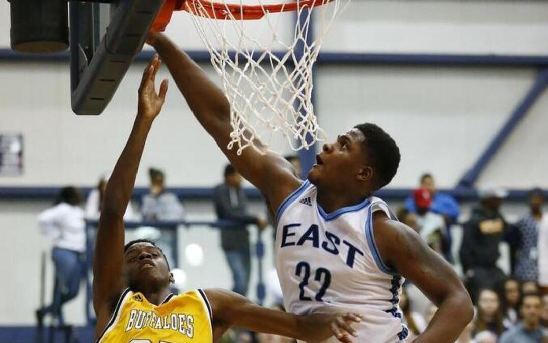 Wichita East’s Xavier Kelly, right, blocks a shot by Southeast’s Richard Reed in the first half Tuesday night. East won 68-66.