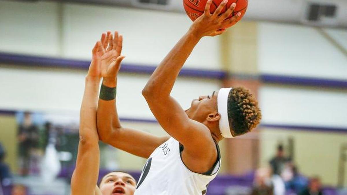 Southeast's Jerrick Harding drives to the basket against KC Harmon’s Andre Jackson in the fourth quarter during the Valley Center Invitational Tournament Thursday. (Jan. 21, 2016)