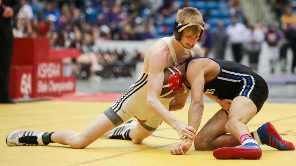 Campus’ Boo Dryden stuffs a takedown attempt from South’s Dallas Wilson in the 6A 120-pound weight division.