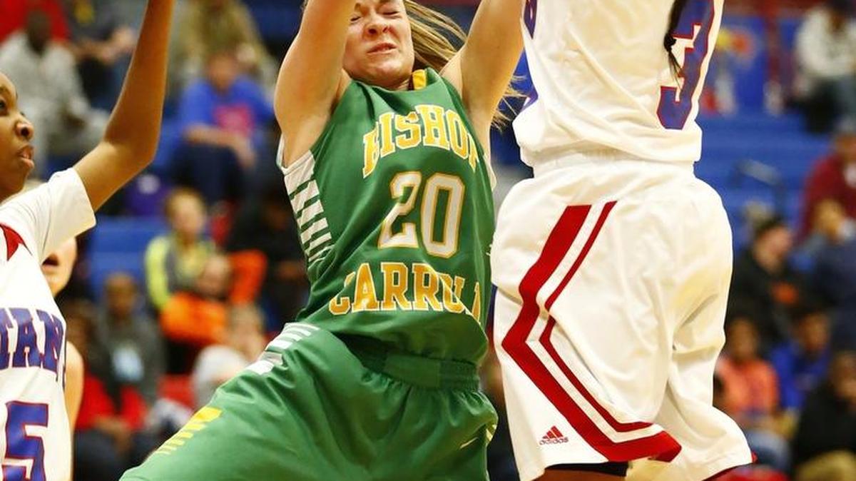 Carroll's Brynn Maul, left, is tied up by South's Trezure Jobe as she tries to shoot in the third quarter Friday night.