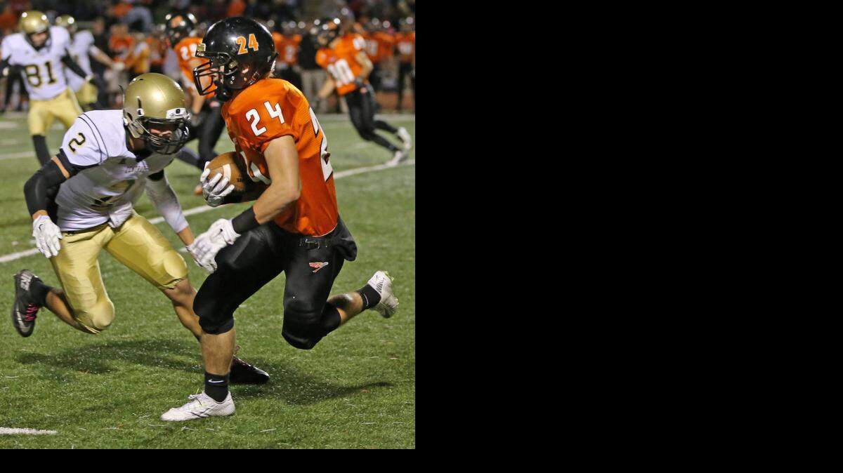 
Augusta’s Connor Hurst makes a catch and fights for extra yards against Andover Central on Friday night in Augusta.
