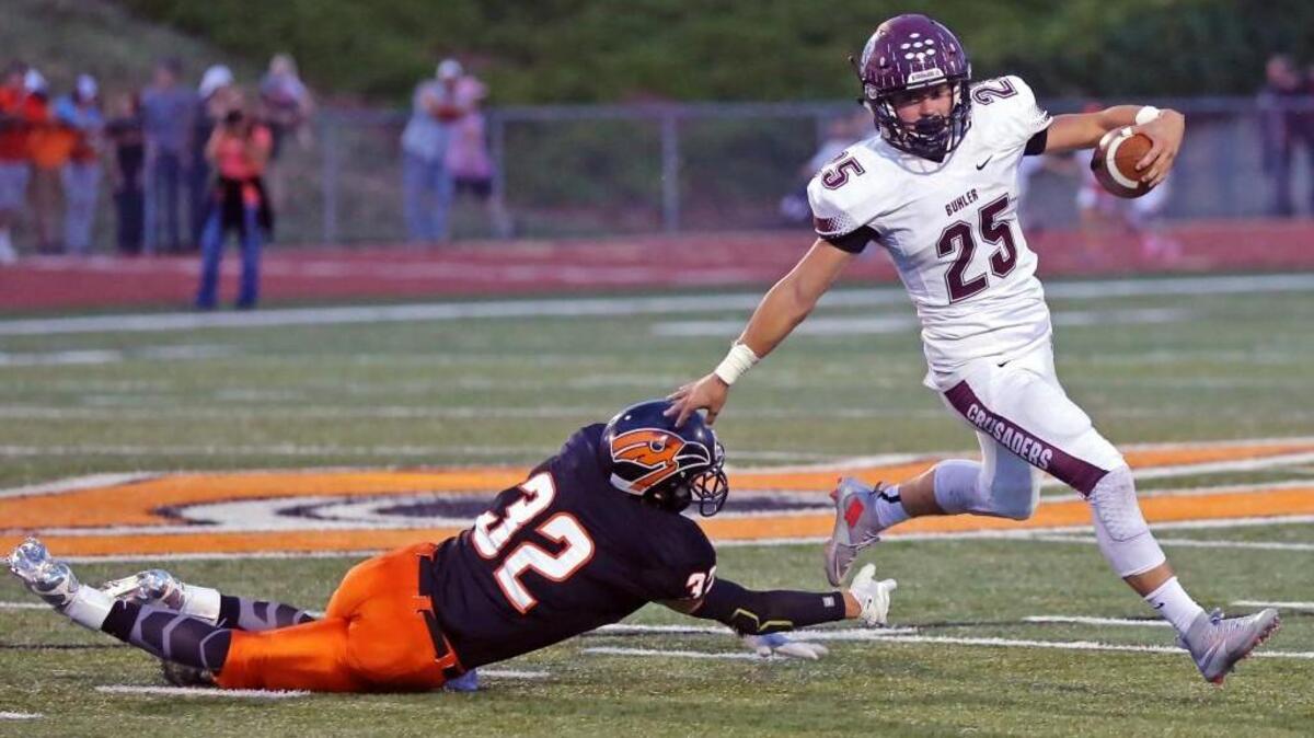 
Buhler’s Dillon Engelland (25), stiff arms Augusta’s Gannon Marcotte at midfield, leading to a large gain early in the first half Friday in Augusta.
