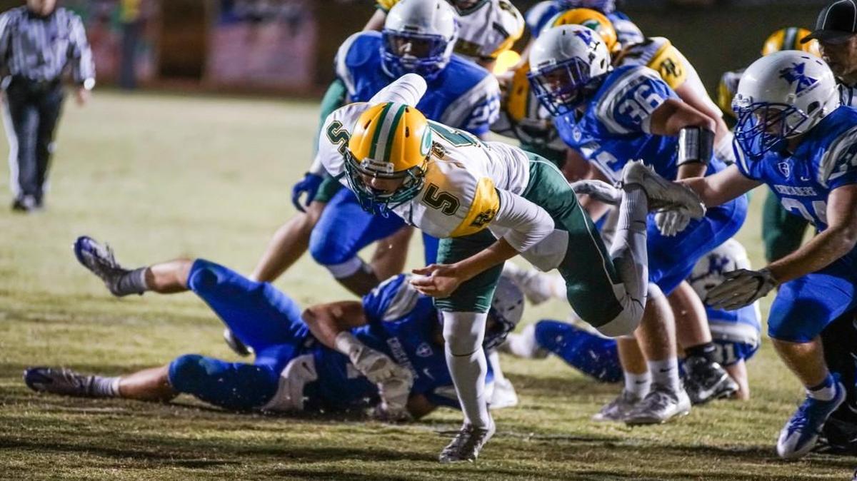 Bishop Carroll quarter back Cade Becker lunges into the end zone for a touchdown against Kapaun in the second quarter Friday night at Cessna Stadium.