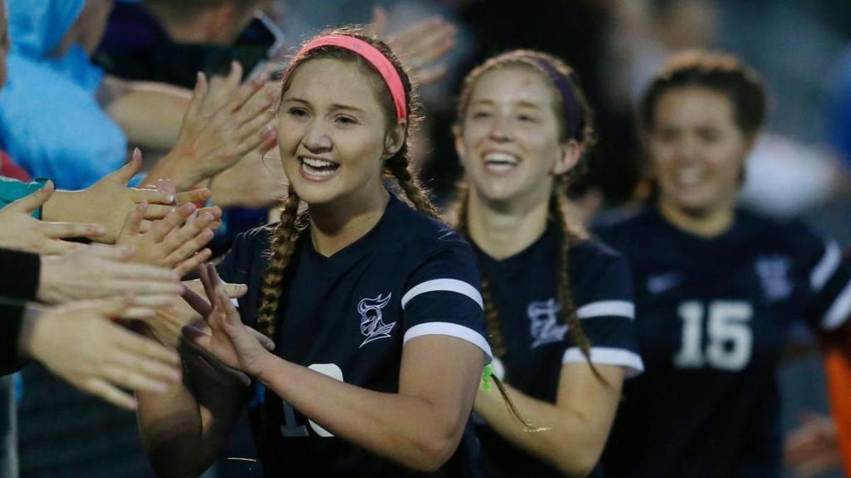 Trinity Academy’s Kaylee Friedberg celebrates with fans after Trinity defeated DeSoto 3-2 in overtime in the Class 4A girls soccer semifinals Friday.