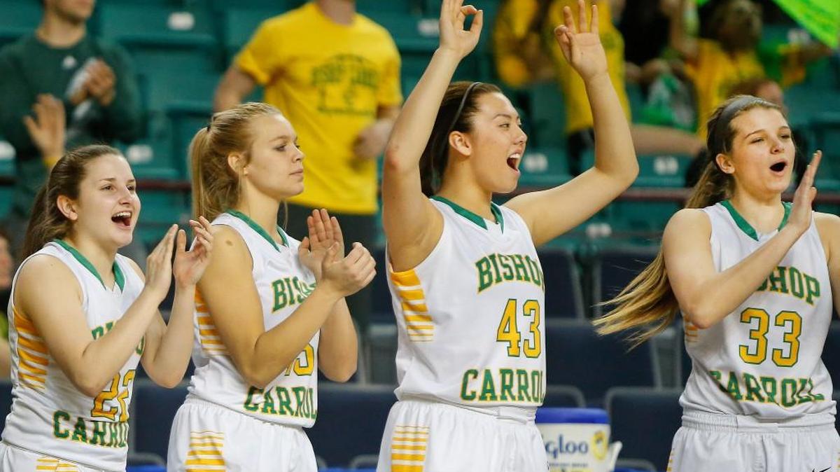 The Carroll bench reacts after a three-pointer by Abby Sauber during the second half of Thursday night’s 5A quarterfinal win over Goddard.